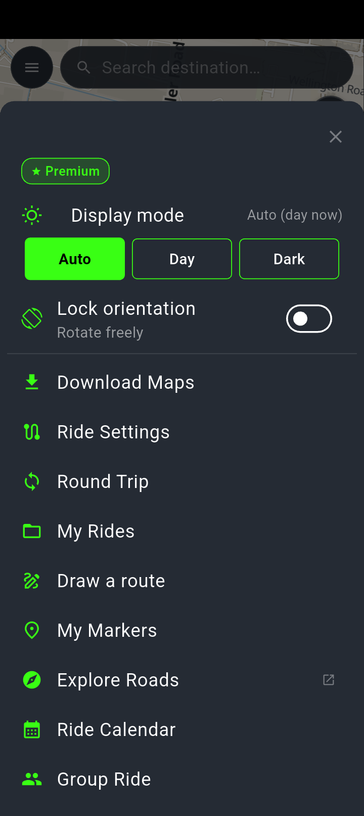 The NavForge menu sheet: a Premium badge, Display mode with Auto selected and the note Auto (day now), Lock orientation set to Rotate freely, then Download Maps, Ride Settings, Round Trip, My Rides, Draw a route, My Markers, Explore Roads, Ride Calendar and Group Ride, with Report a problem and Settings below the fold.